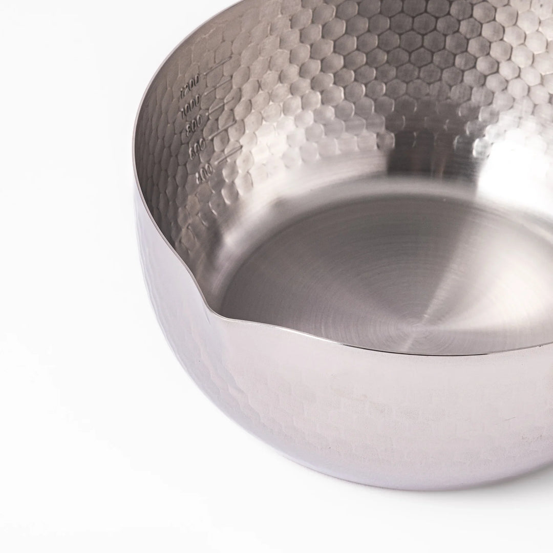 Stainless steel Yukihira pot with a wooden handle featuring a hammered texture and dual pour spouts.