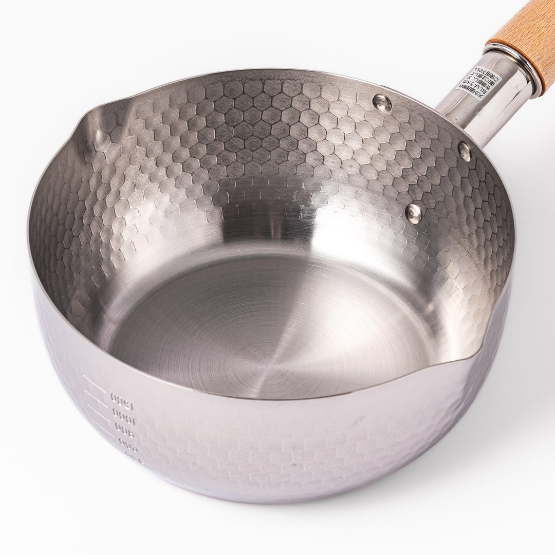 Stainless steel Yukihira pot with a wooden handle featuring a hammered texture and dual pour spouts.