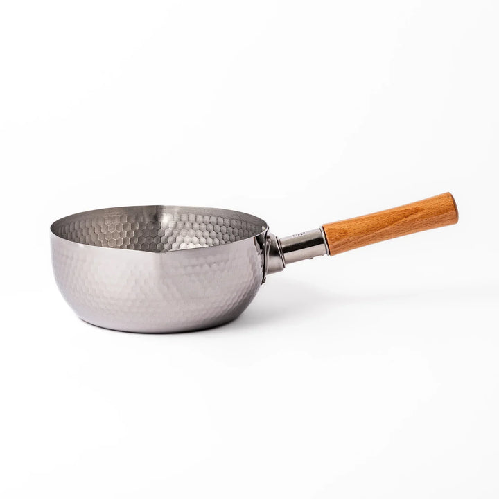 Japanese stainless steel yukihira pot with wooden handle and hammered texture, ideal for boiling soup or simmering dishes
