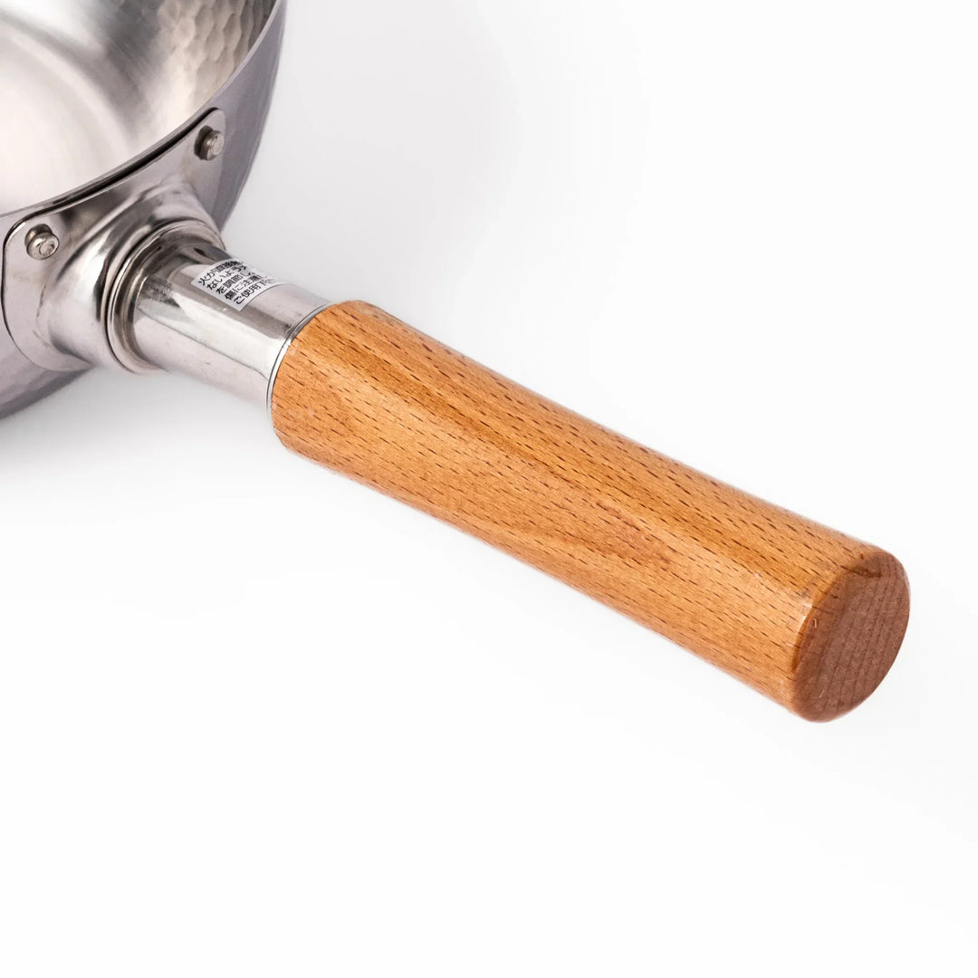 Japanese stainless steel yukihira pot with wooden handle and hammered texture, ideal for boiling soup or simmering dishes