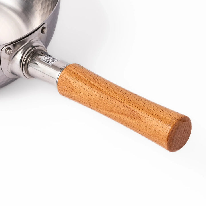 Japanese stainless steel yukihira pot with wooden handle and hammered texture, ideal for boiling soup or simmering dishes