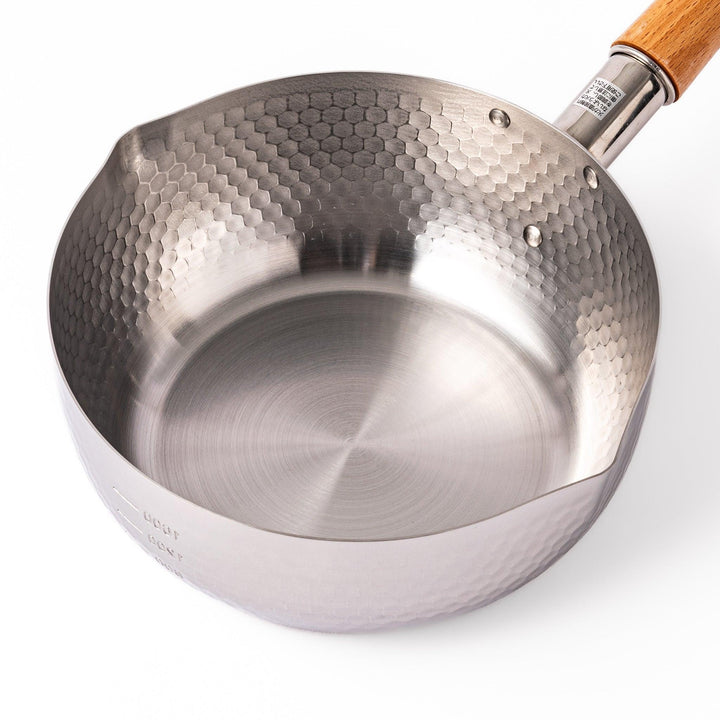Japanese stainless steel yukihira pot with wooden handle and hammered texture, ideal for boiling soup or simmering dishes