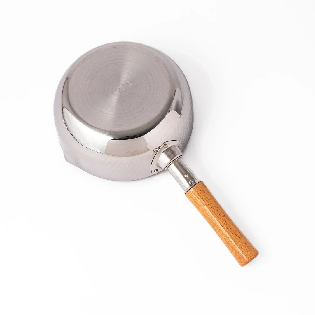 Japanese stainless steel yukihira pot with wooden handle and hammered texture, ideal for boiling soup or simmering dishes