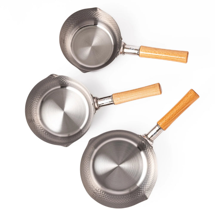 Japanese stainless steel yukihira pots with hammered finish and wooden handles shown in three sizes for versatile kitchen use