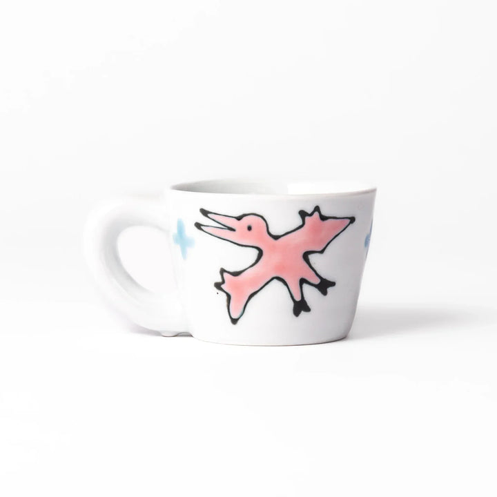 White ceramic kids mug featuring green stegosaurus dinosaur with round handle, shown on white background