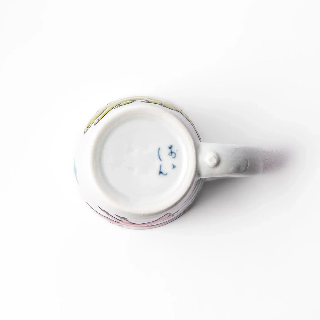 White ceramic kids mug featuring green stegosaurus dinosaur with round handle, shown on white background