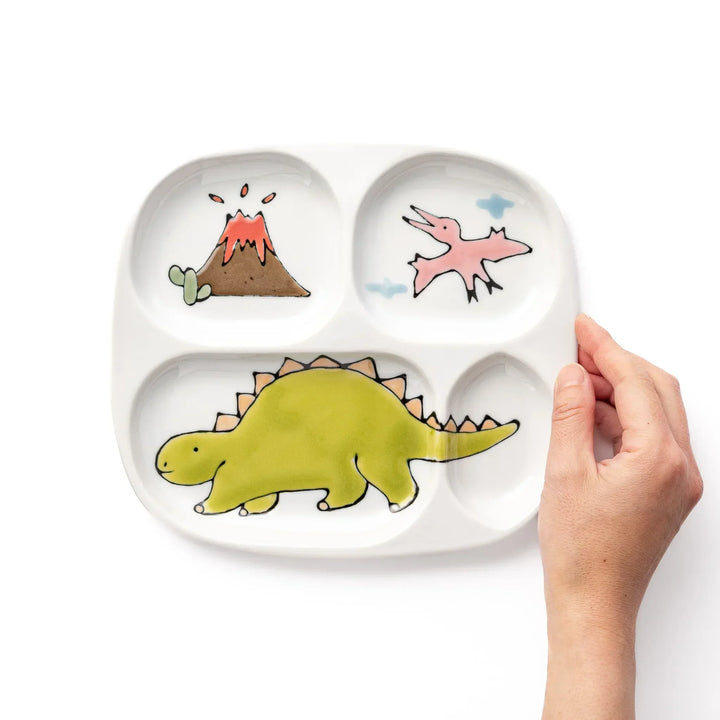 White ceramic kids divided plate with green stegosaurus, red erupting volcano, pink pterodactyl and blue cloud motifs