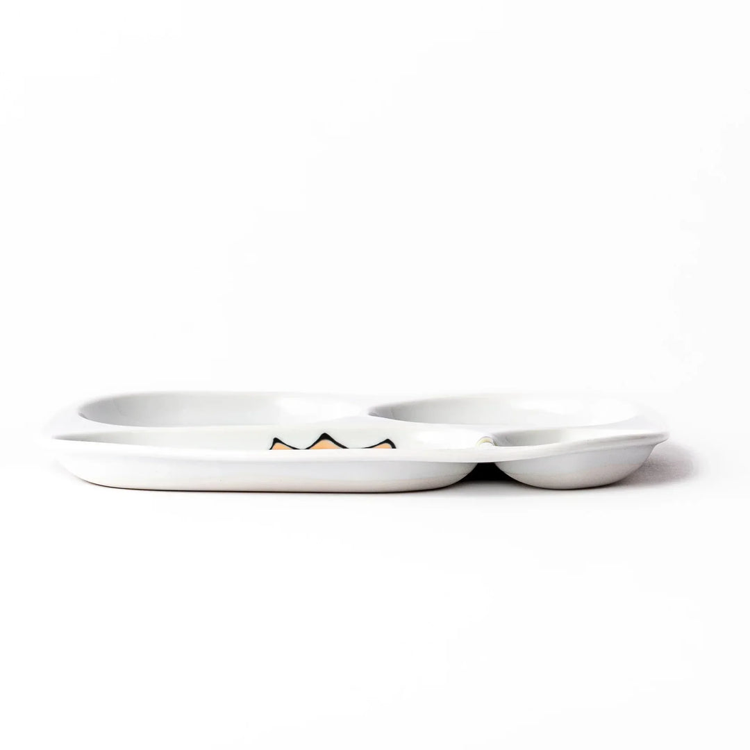 White ceramic kids divided plate with green stegosaurus, red erupting volcano, pink pterodactyl and blue cloud motifs