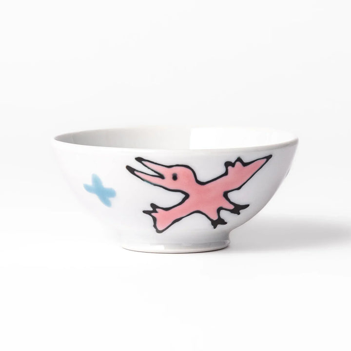 White ceramic kids rice bowl with green stegosaurus dinosaur motif and blue cloud accents