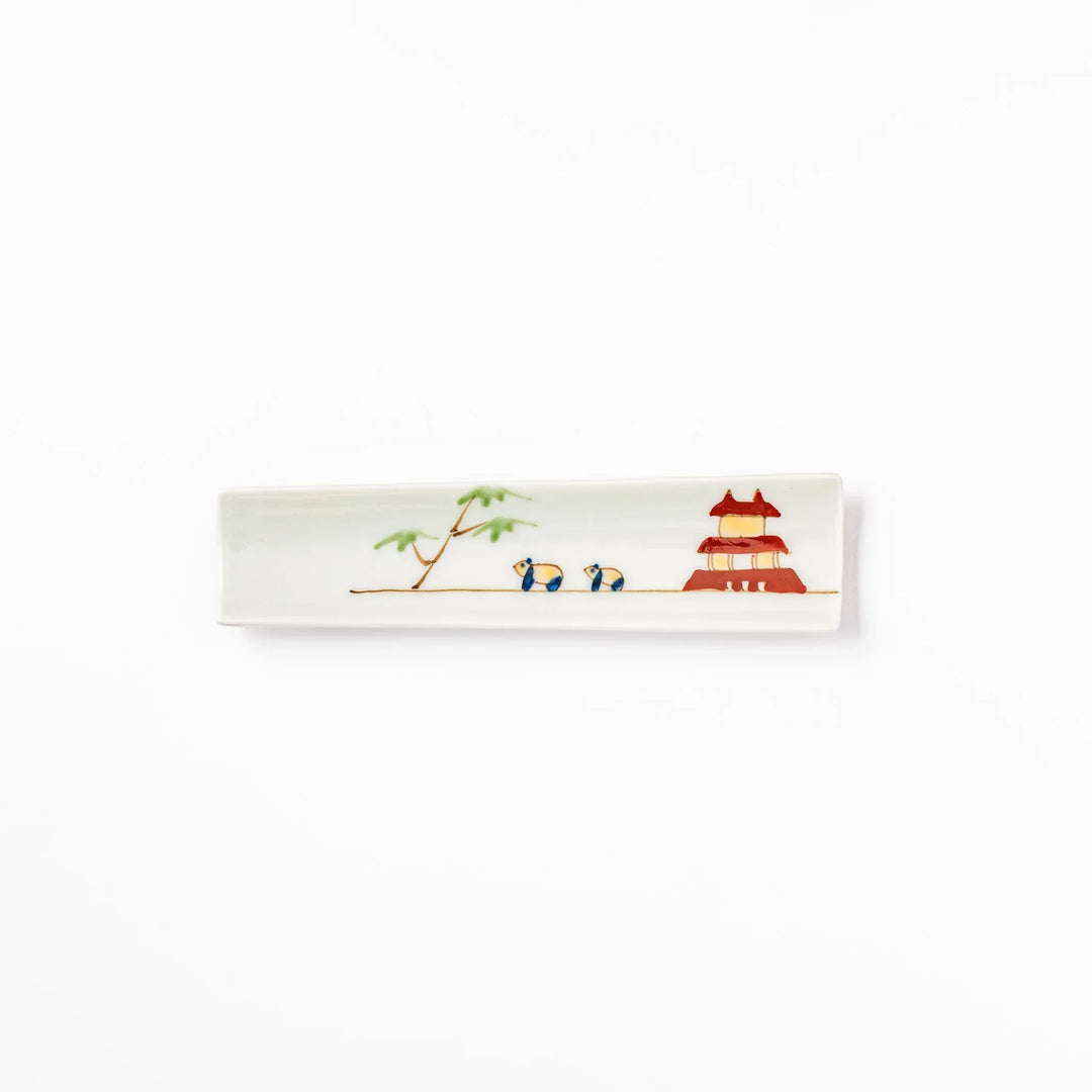 Japanese porcelain chopstick rest with whimsical China design featuring red pagoda, pandas, bamboo, and green tree accents