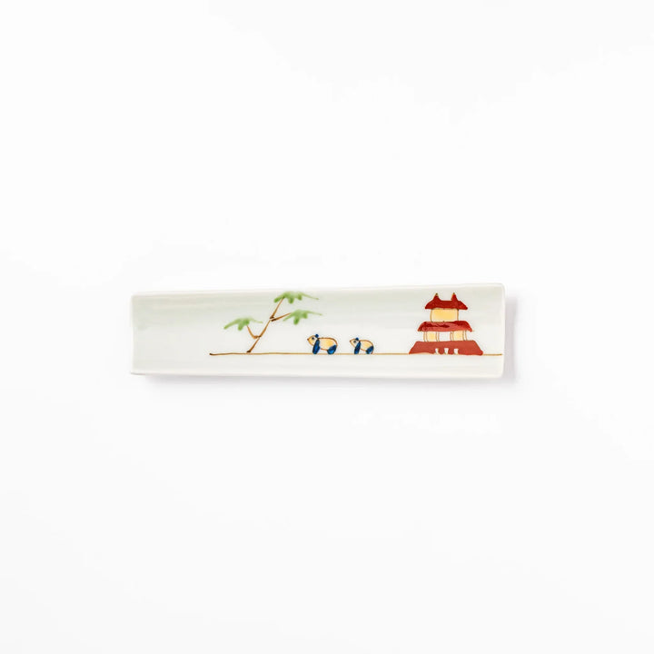 Japanese porcelain chopstick rest with whimsical China design featuring red pagoda, pandas, bamboo, and green tree accents