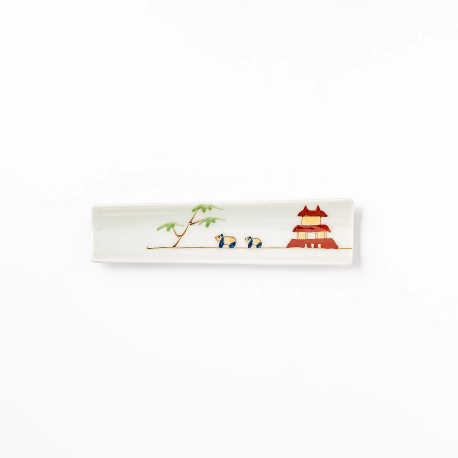 Japanese porcelain chopstick rest with whimsical China design featuring red pagoda, pandas, bamboo, and green tree accents