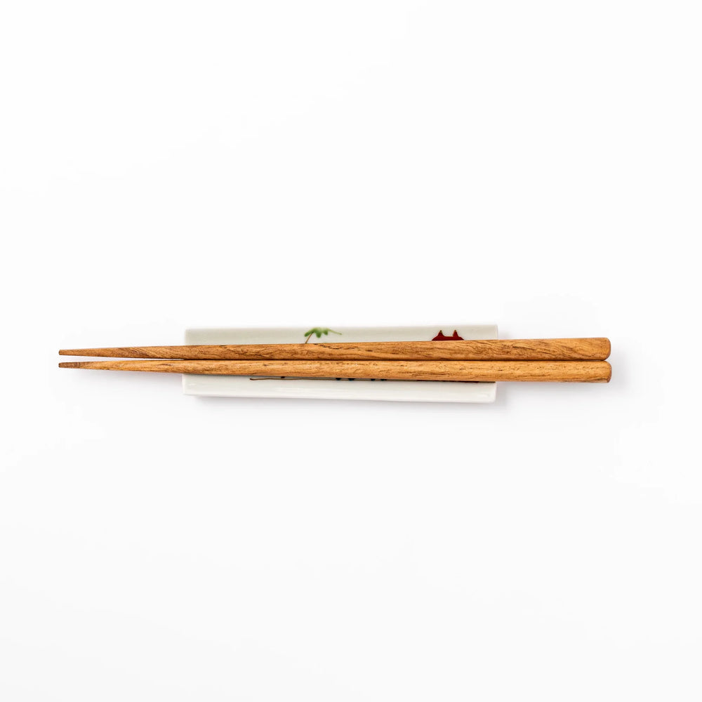 Japanese porcelain chopstick rest with whimsical China design featuring red pagoda, pandas, bamboo, and green tree accents