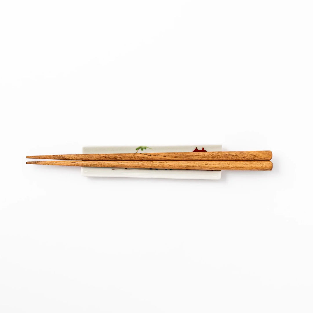 Japanese porcelain chopstick rest with whimsical China design featuring red pagoda, pandas, bamboo, and green tree accents