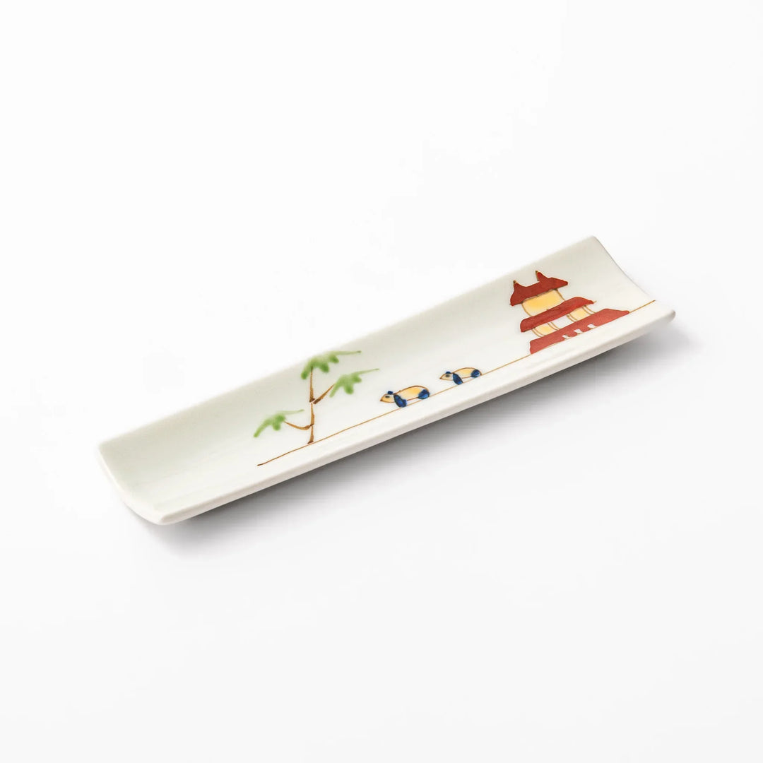 Japanese porcelain chopstick rest with whimsical China design featuring red pagoda, pandas, bamboo, and green tree accents