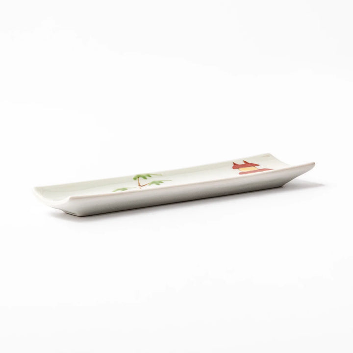 Japanese porcelain chopstick rest with whimsical China design featuring red pagoda, pandas, bamboo, and green tree accents