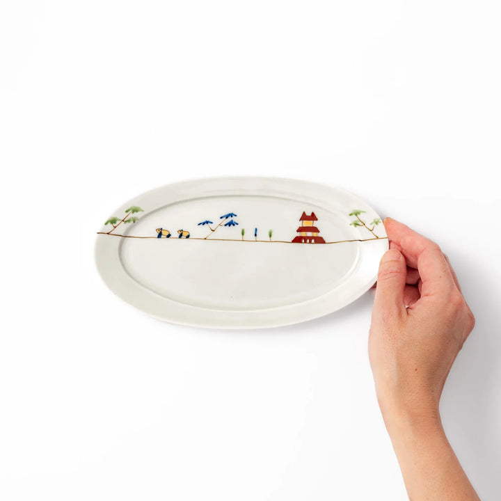 Japanese porcelain oval plate with whimsical China design featuring pandas, bamboo trees, and a traditional red pagoda