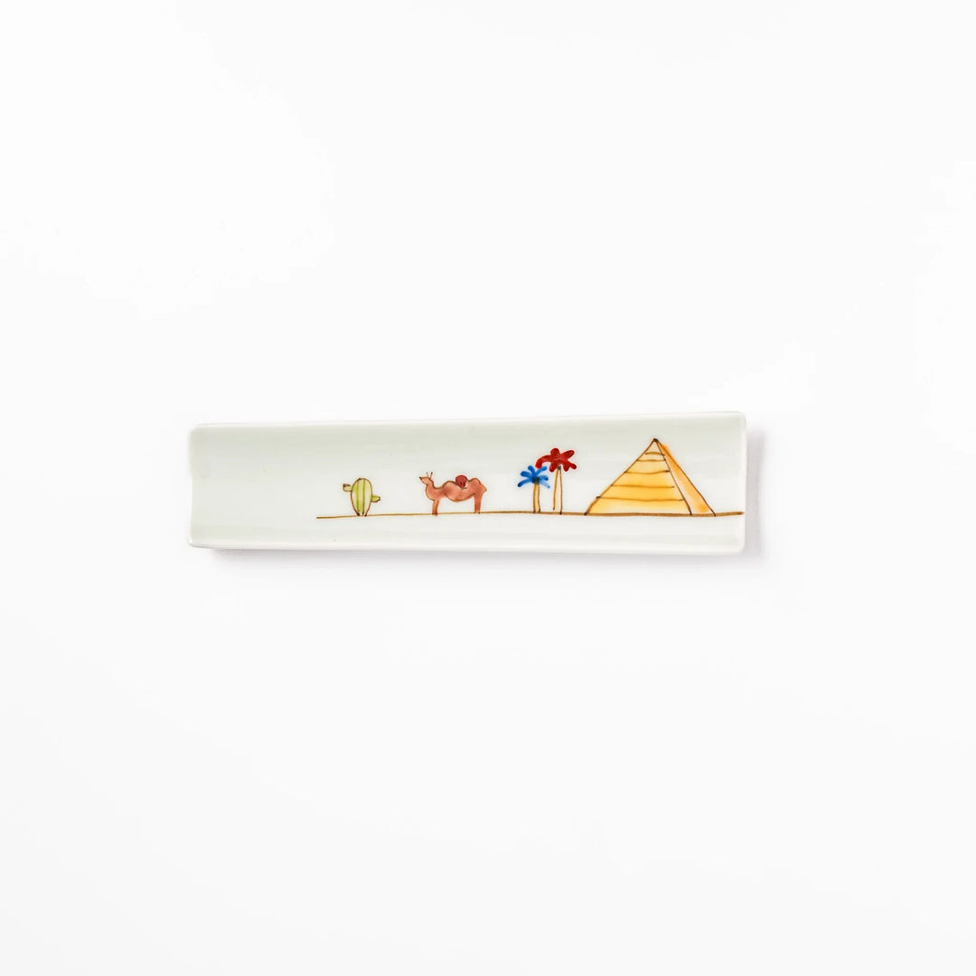 Japanese porcelain chopstick rest with whimsical Egypt design featuring pyramid, camel, cactus, and colorful palm trees
