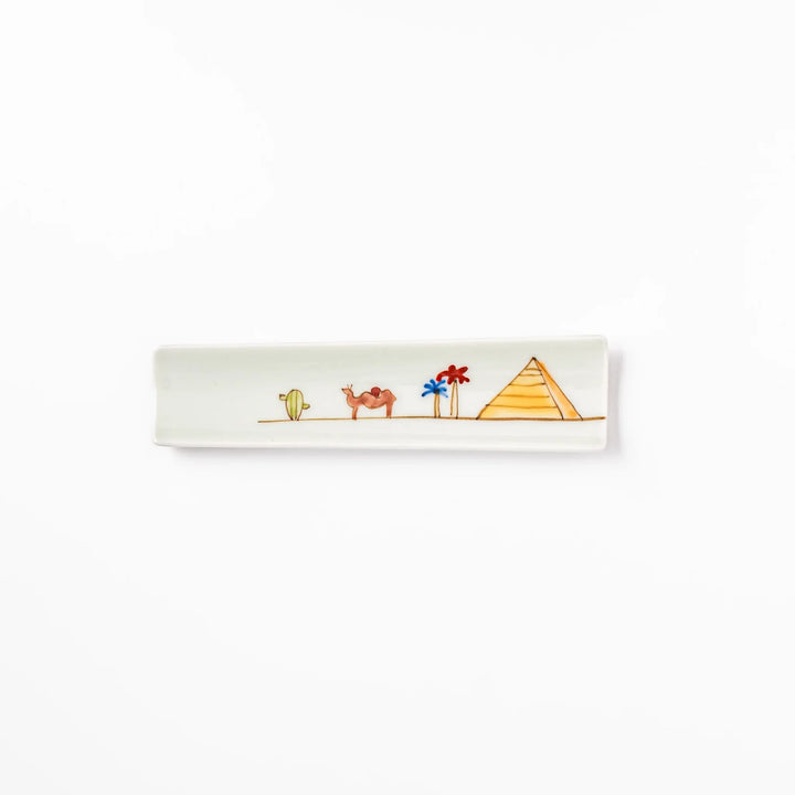 Japanese porcelain chopstick rest with whimsical Egypt design featuring pyramid, camel, cactus, and colorful palm trees