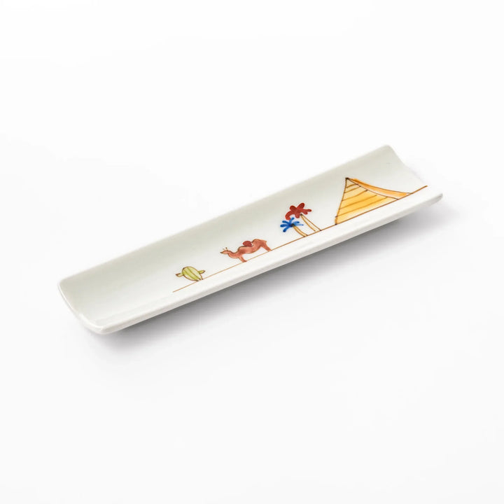 Japanese porcelain chopstick rest with whimsical Egypt design featuring pyramid, camel, cactus, and colorful palm trees