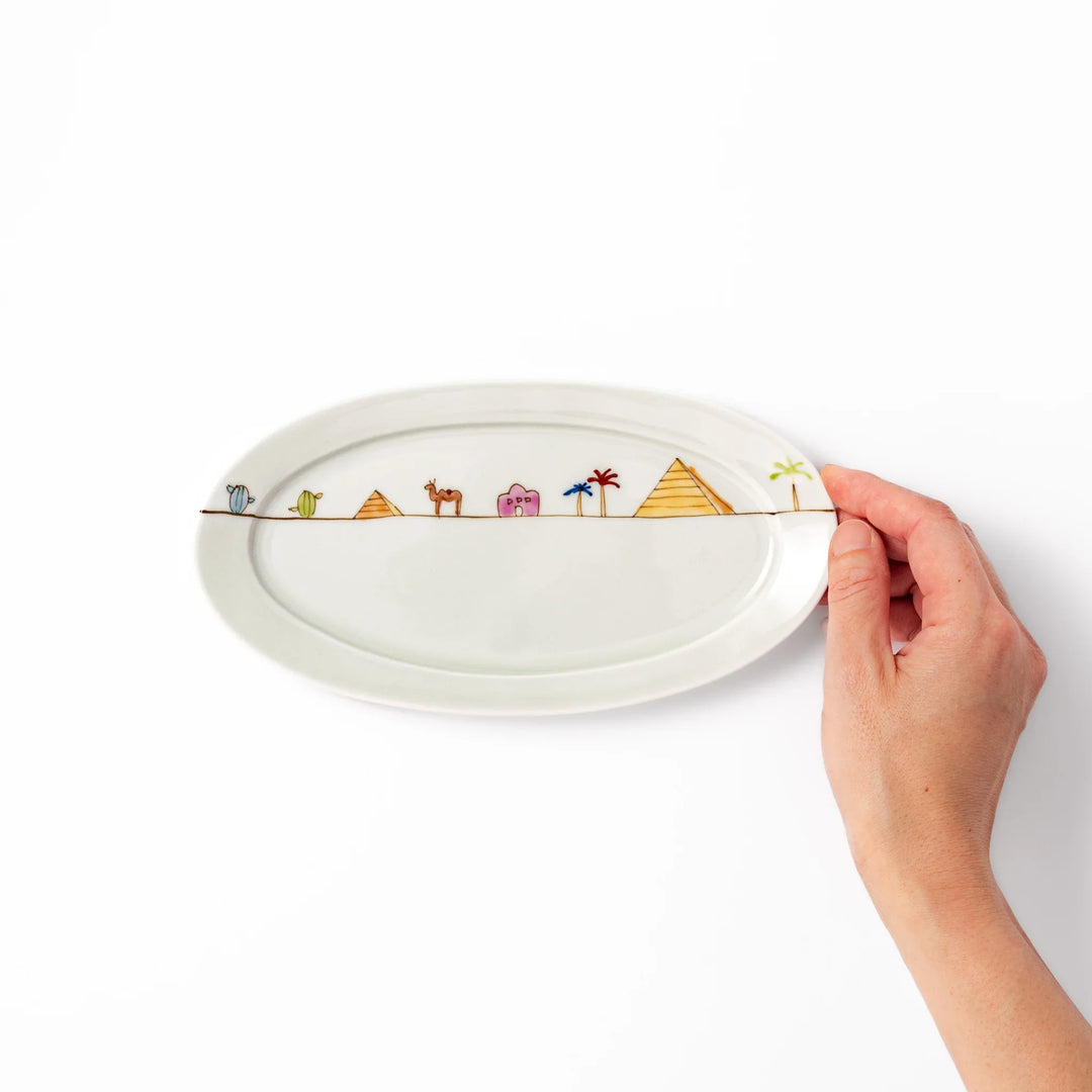 Japanese porcelain oval plate with whimsical Egypt design featuring pyramids, camel, palm trees, and desert-inspired details