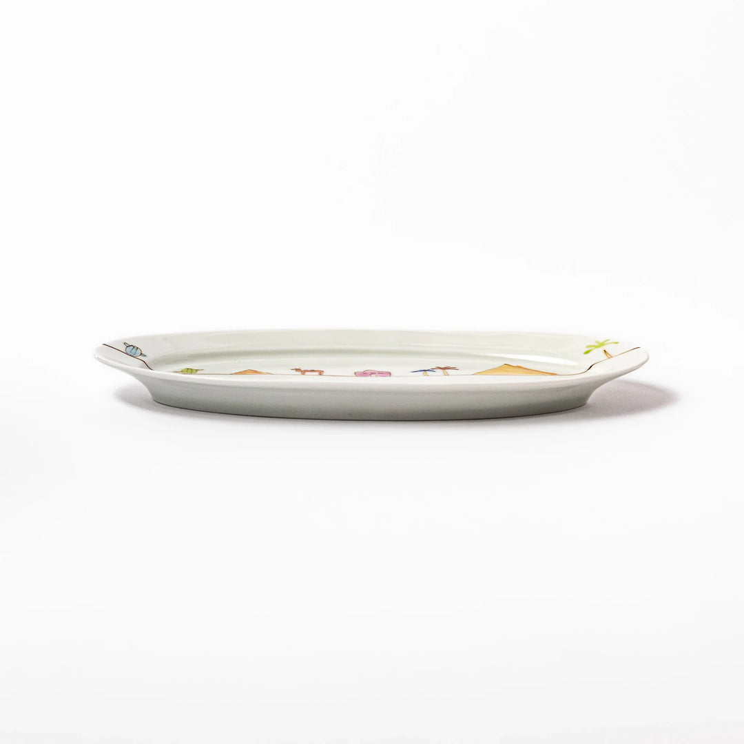 Japanese porcelain oval plate with whimsical Egypt design featuring pyramids, camel, palm trees, and desert-inspired details