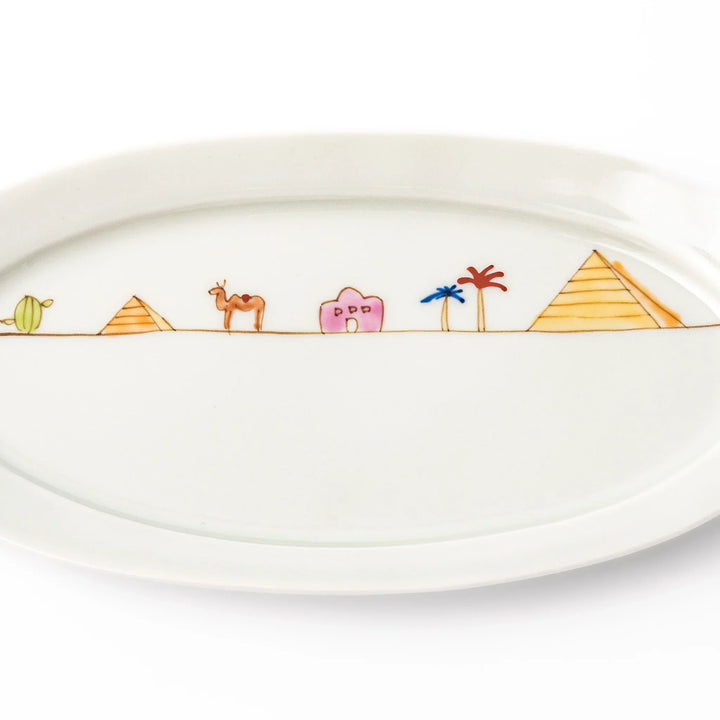 Japanese porcelain oval plate with whimsical Egypt design featuring pyramids, camel, palm trees, and desert-inspired details