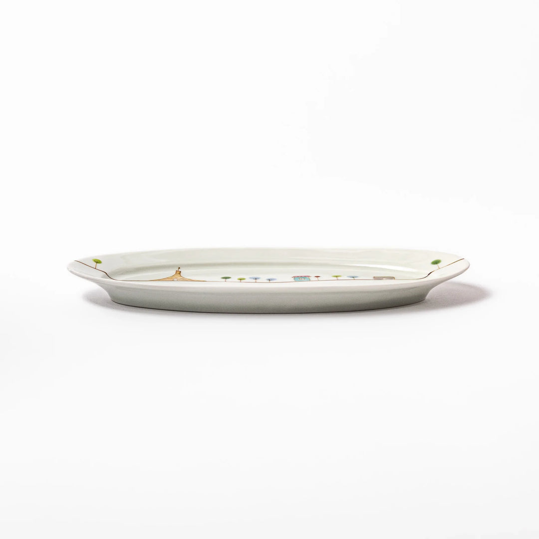 Japanese porcelain oval plate with whimsical France design featuring Eiffel Tower, Arc de Triomphe, trees, and colorful house