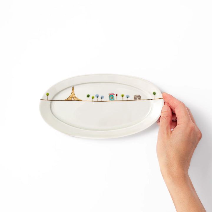 Japanese porcelain oval plate with whimsical France design featuring Eiffel Tower, Arc de Triomphe, trees, and colorful house