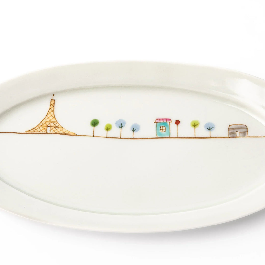 Japanese porcelain oval plate with whimsical France design featuring Eiffel Tower, Arc de Triomphe, trees, and colorful house