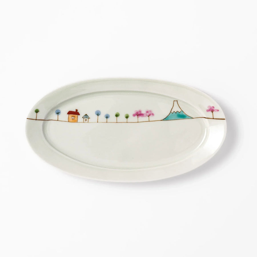 Japanese porcelain oval plate with whimsical Japan design featuring Mount Fuji, cherry blossoms, houses, and colorful trees