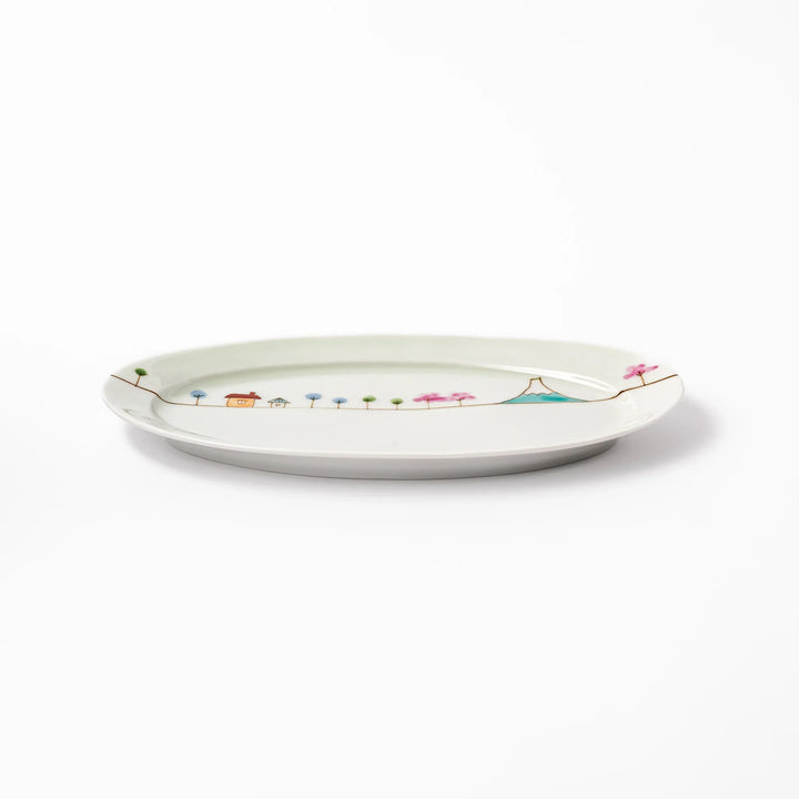 Japanese porcelain oval plate with whimsical Japan design featuring Mount Fuji, cherry blossoms, houses, and colorful trees