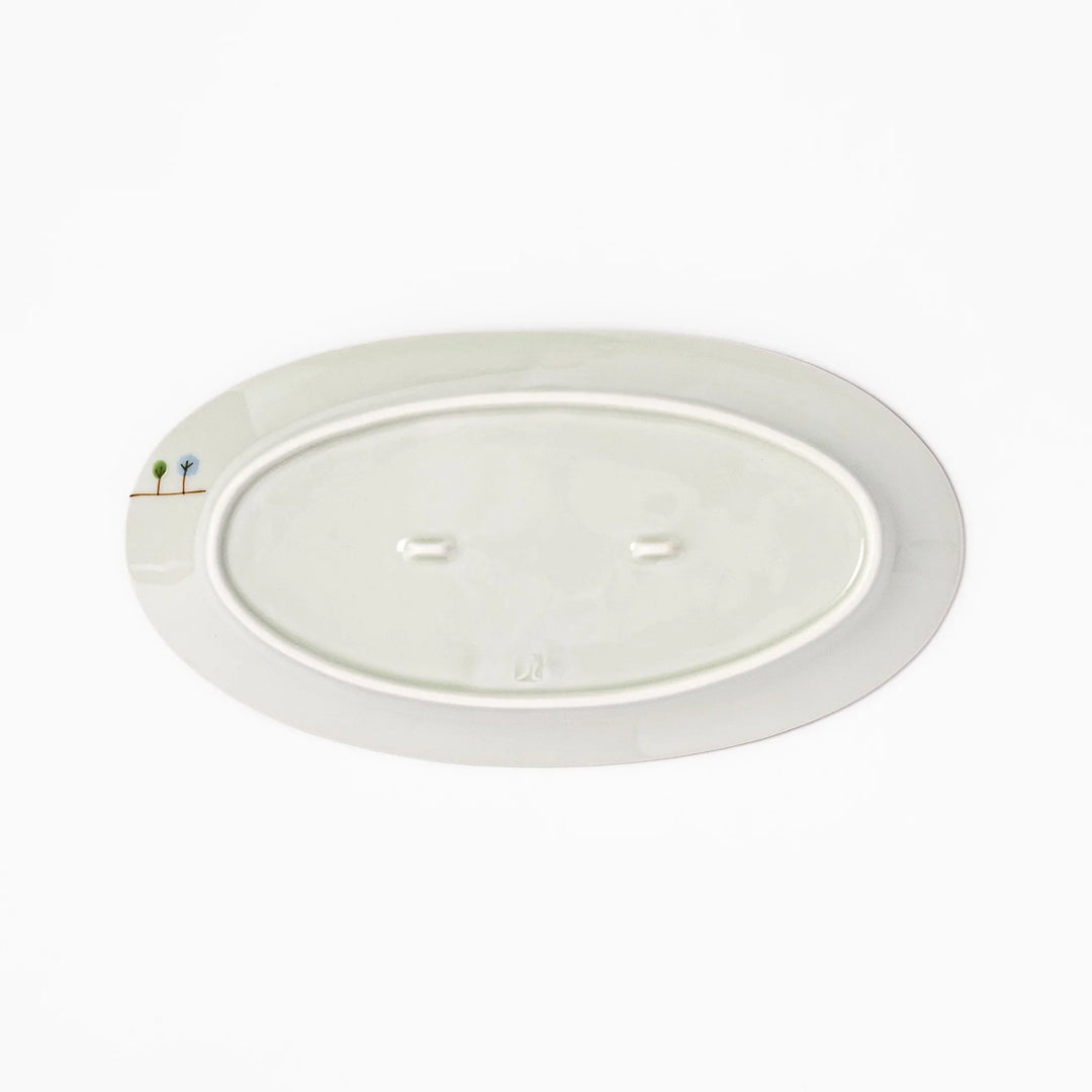 Japanese porcelain oval plate with whimsical Japan design featuring Mount Fuji, cherry blossoms, houses, and colorful trees