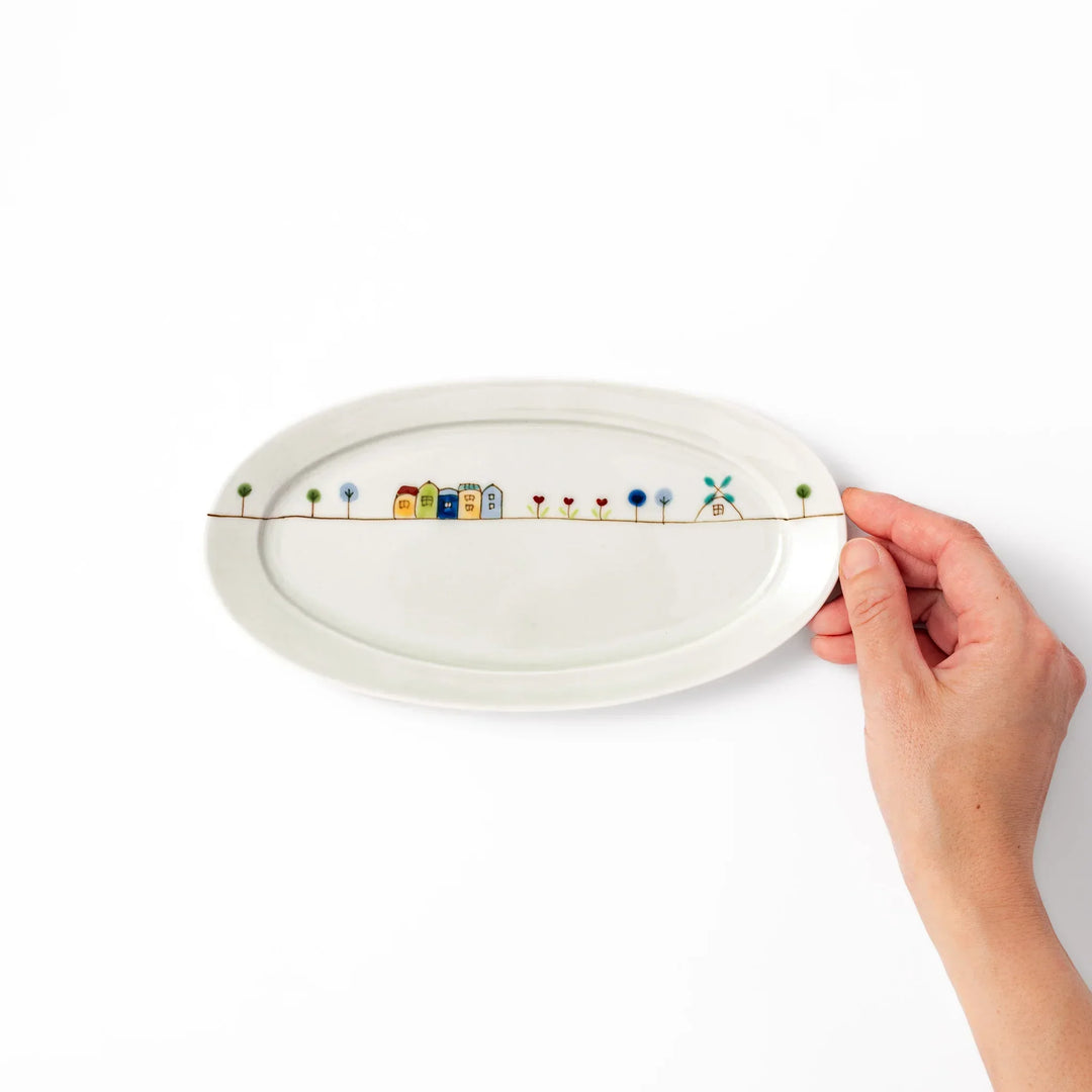Japanese porcelain oval plate with whimsical Netherlands design featuring colorful houses, tulips, trees, and a blue windmill