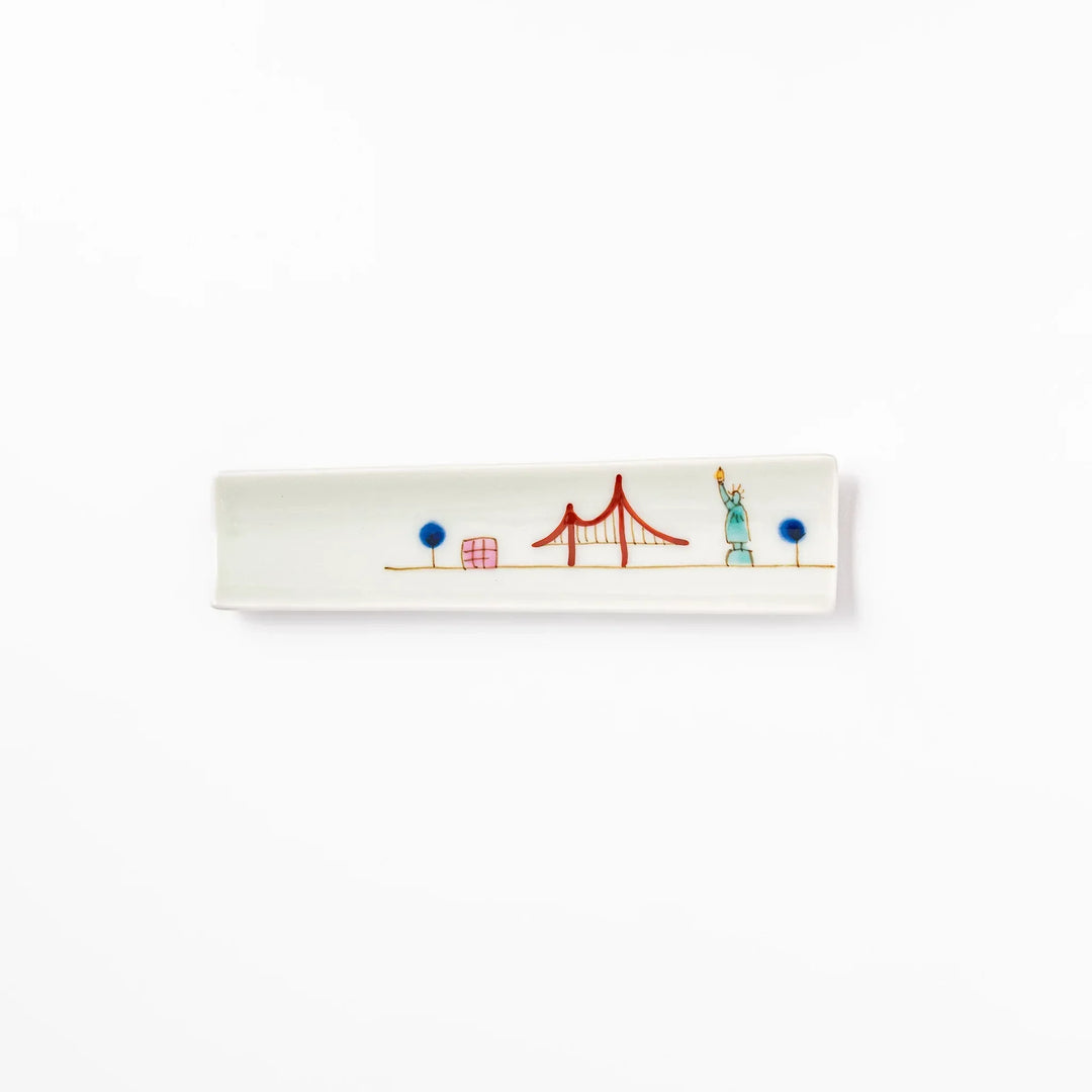 Japanese porcelain chopstick rest with USA design featuring Statue of Liberty, red bridge, and colorful cityscape accents