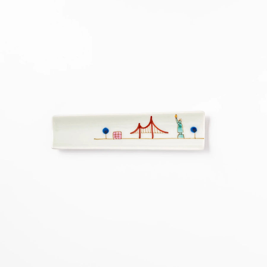 Japanese porcelain chopstick rest with USA design featuring Statue of Liberty, red bridge, and colorful cityscape accents