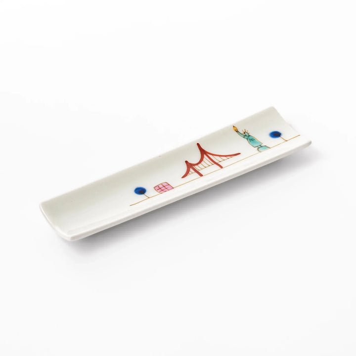 Japanese porcelain chopstick rest with USA design featuring Statue of Liberty, red bridge, and colorful cityscape accents