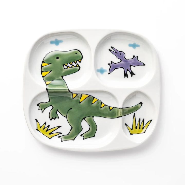 White ceramic kids divided plate with green T-Rex, purple pterodactyl, yellow grass and blue cloud accents
