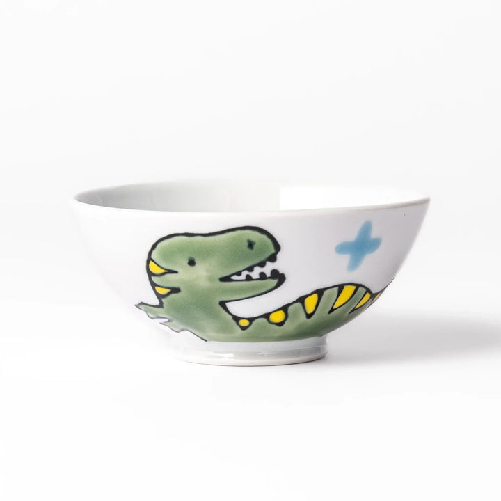 White ceramic kids rice bowl featuring green T-Rex dinosaur graphic with yellow accents and blue cloud motifs