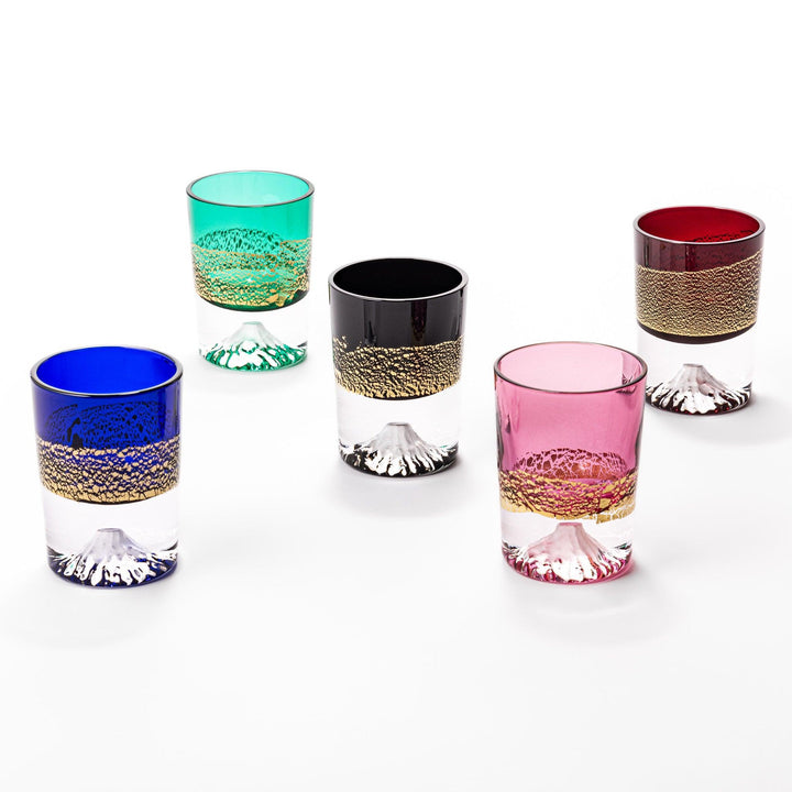 Five colorful sake glasses with gold-leaf Fuji designs, blending vibrant color with traditional artistry.