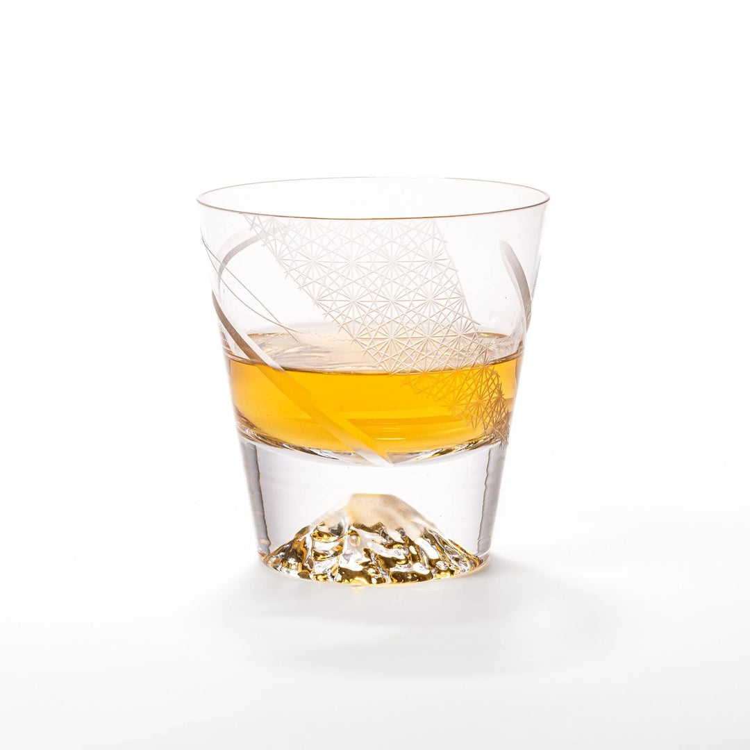 Clear glass tumbler with etched starburst motifs and diagonal swirl atop 3D Mount Fuji base for drinks.