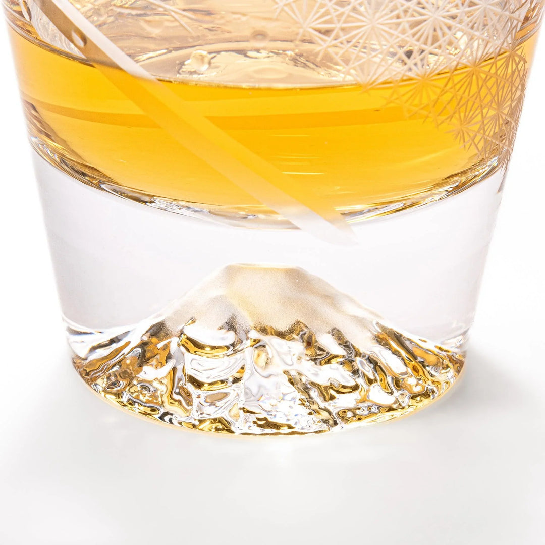 Clear glass tumbler with etched starburst motifs and diagonal swirl atop 3D Mount Fuji base for drinks.