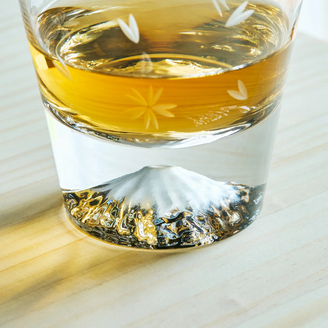 Close-up of a Kiriko Japanese whiskey glass with Mt. Fuji design at the base and delicate floral cut patterns.