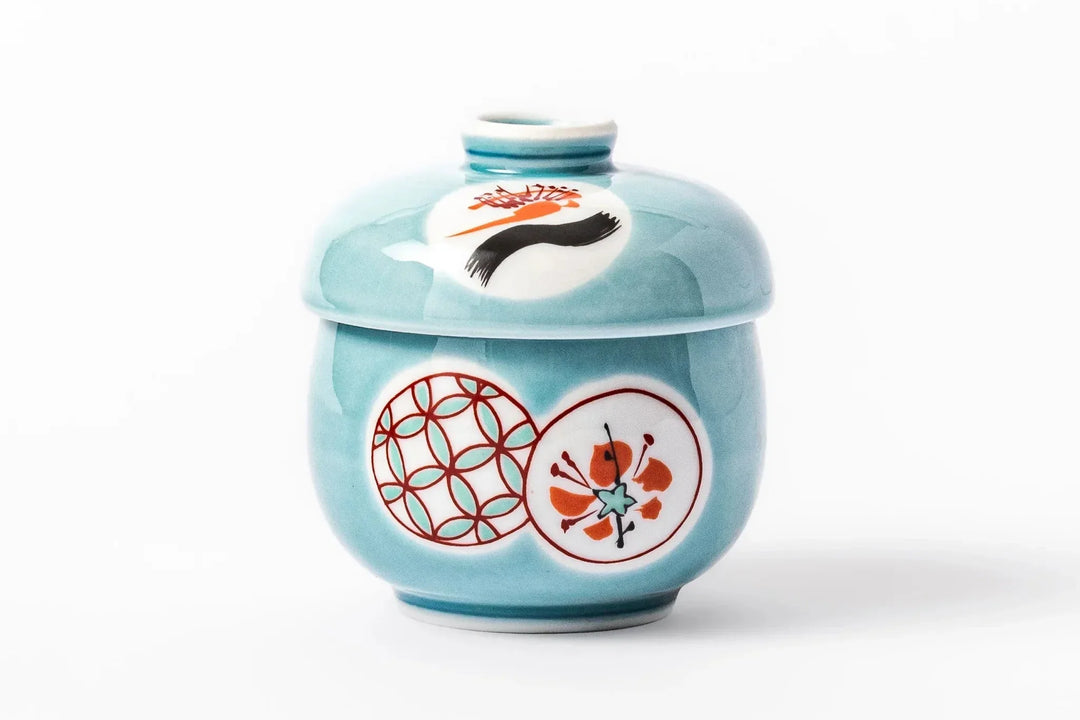 Light blue chawanmushi bowl with red and white circular motifs and a matching lid on a clean white background