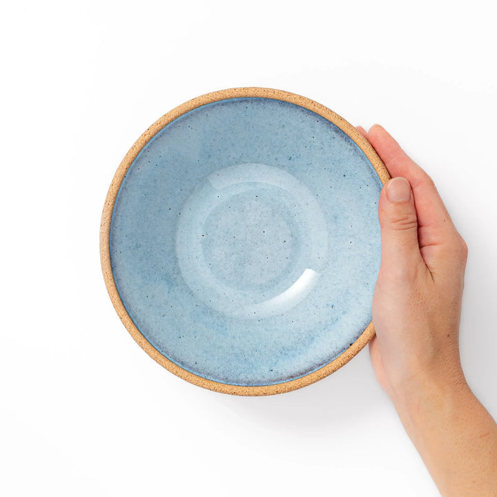 Terracotta blue ceramic cereal bowl with rustic brown rim, handcrafted in Japan for serving cereal, soup, or salad.