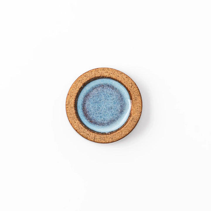 Terracotta blue ceramic chopstick rest with rustic brown rim, handcrafted in Japan for an elegant dining accent.