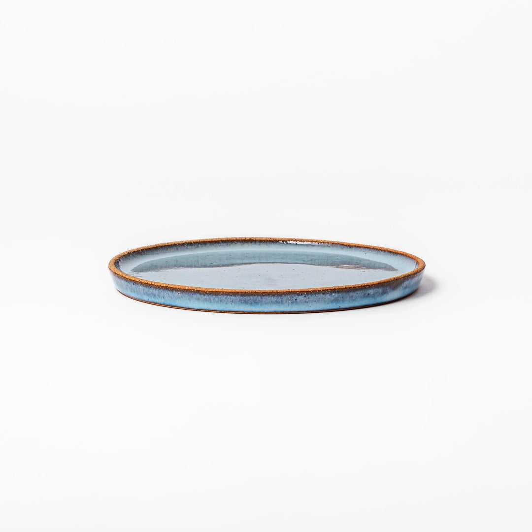 Terracotta blue ceramic dessert plate with rustic brown rim, handcrafted in Japan for serving cake, pastry, or appetizers.