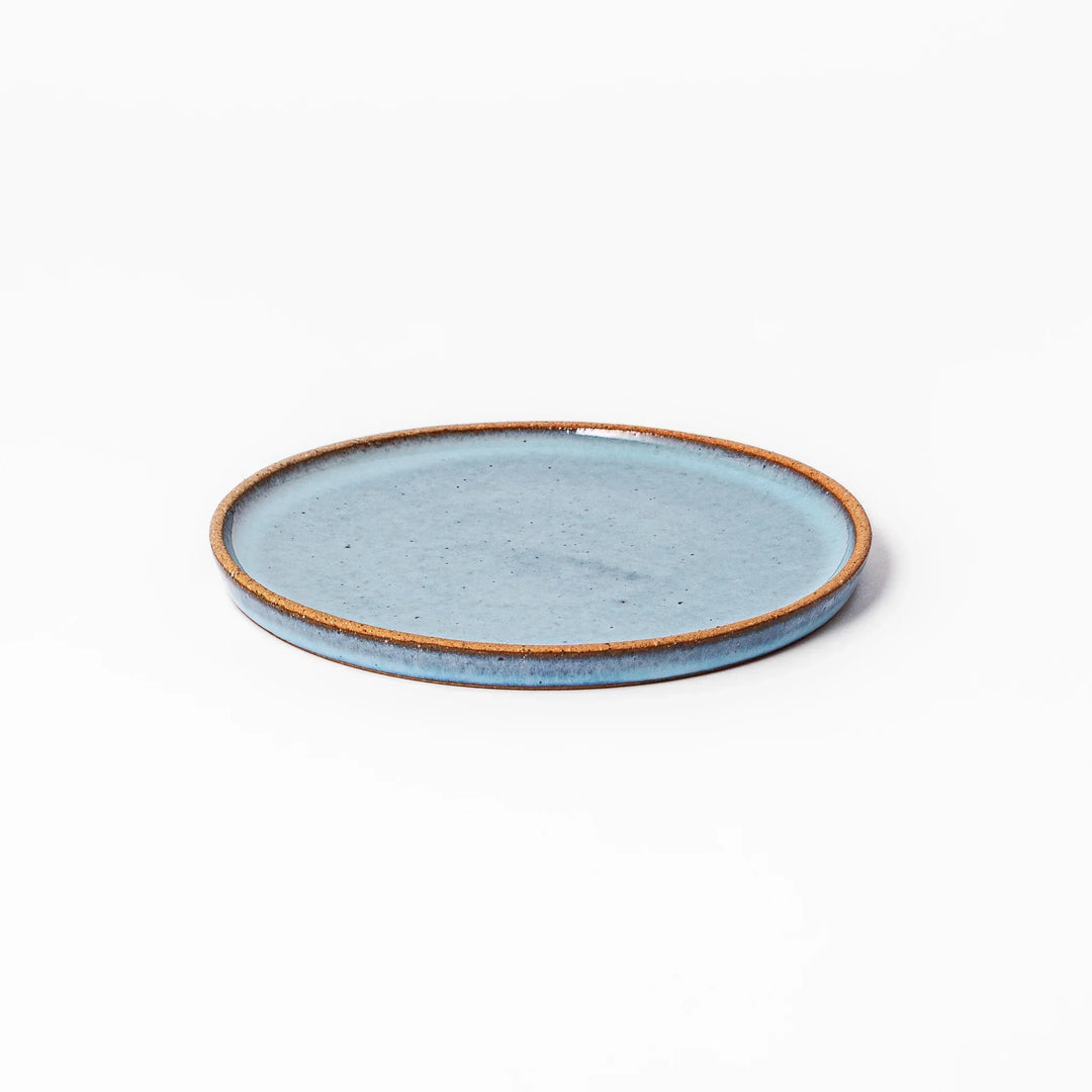 Terracotta blue ceramic dessert plate with rustic brown rim, handcrafted in Japan for serving cake, pastry, or appetizers.