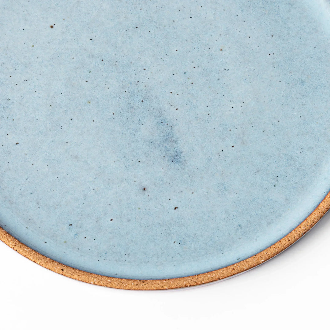 Terracotta blue ceramic dessert plate with rustic brown rim, handcrafted in Japan for serving cake, pastry, or appetizers.