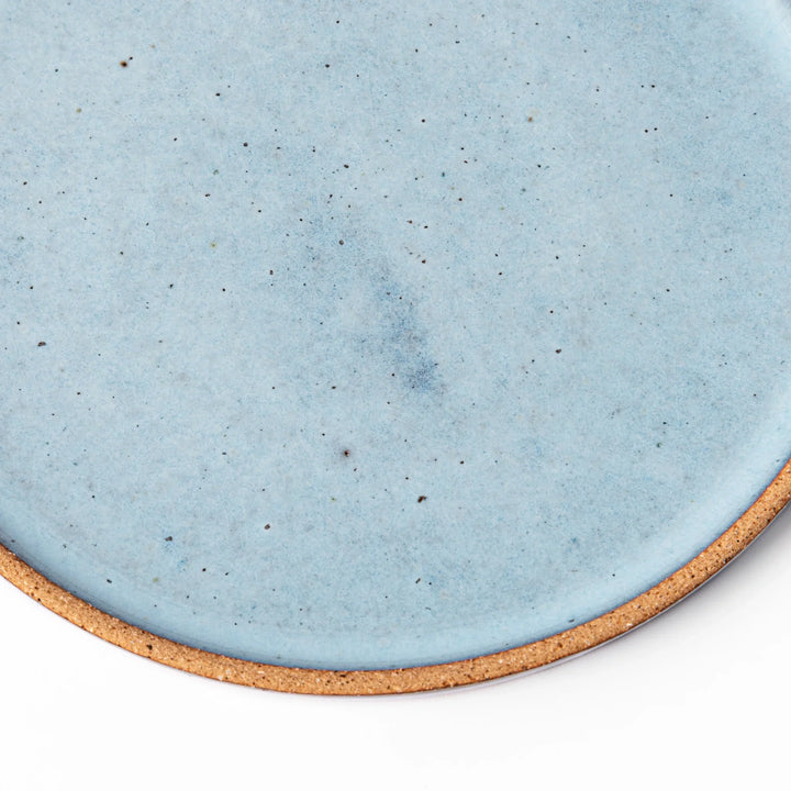 Terracotta blue ceramic dessert plate with rustic brown rim, handcrafted in Japan for serving cake, pastry, or appetizers.